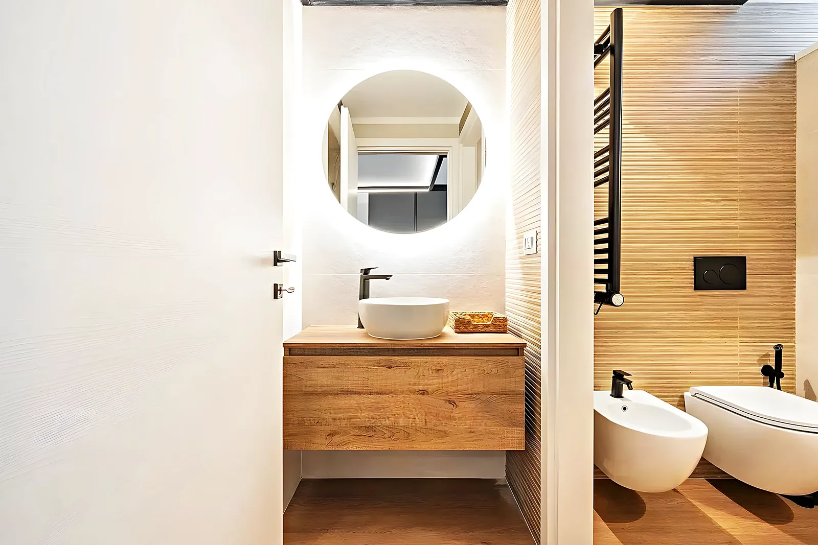 Bathroom with a wooden vanity, countertop basin and black fittings in Vilanova i la Geltrú